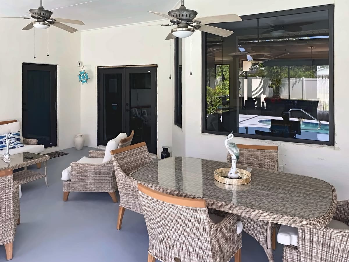 Covered patio with dark-framed French doors and a large window